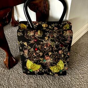 Vintage, embellished brocade handbag with a shell handle.
